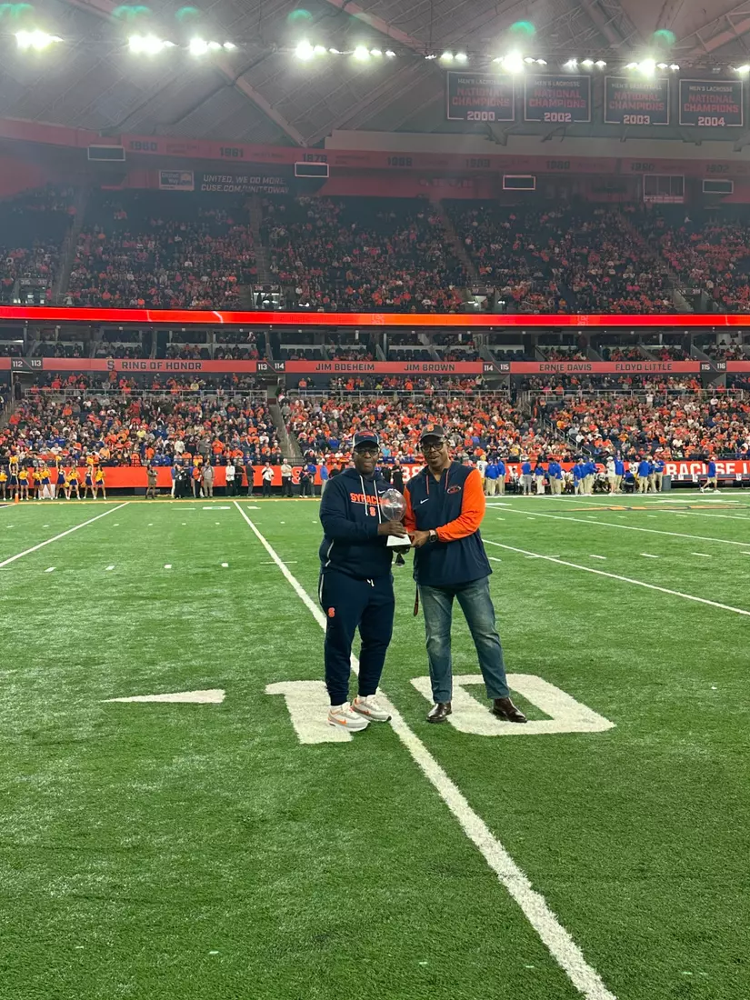 Turnell Sims awarding Carl Jenkins with the Zunic Award