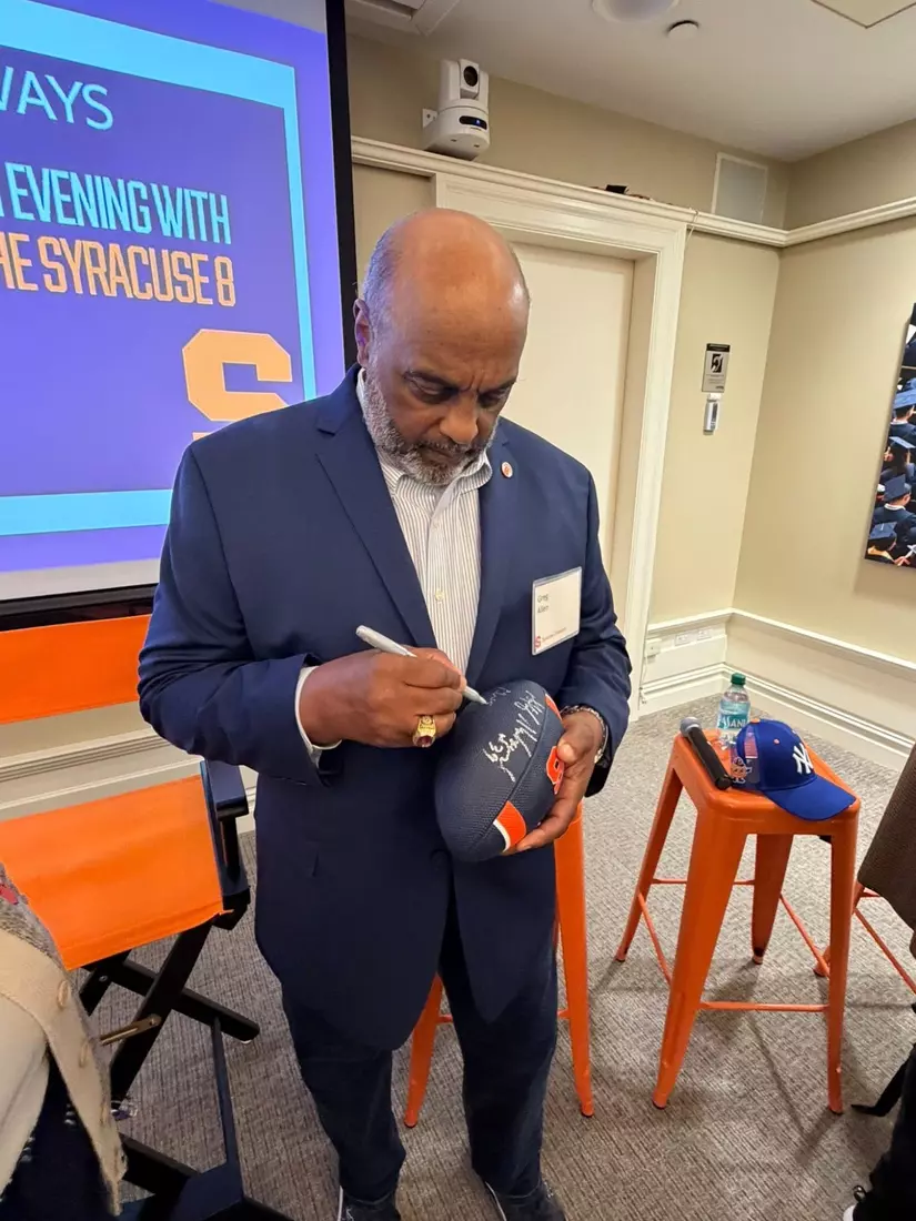 Greg Allen autographing football