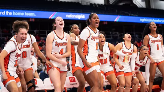 WBB team celebrating on the bench