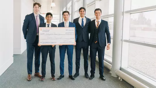 Men's Rowers pose with $3,000 check for placing second at Whitman Real Estate Competition