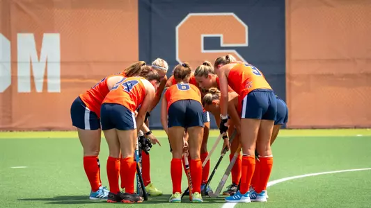 Field hockey huddles before a penalty corner