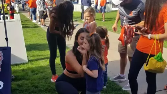 Dance team doing face paint at 'Cuse on the Quad