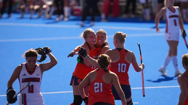 Syracuse field hockey celebrates a goal against Louisville