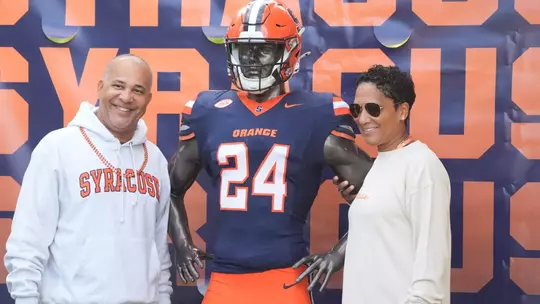 Fans taking a photo with the 'Cuse Uniform Showcase