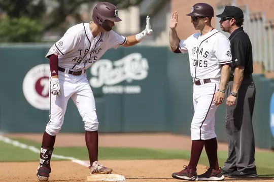 COLLEGE STATION, TX - May 07, 2022 - Infielder Jack Moss #9 of the Texas A&M Aggies and Assistant Coach Michael Earley of the Texas A&M Aggies during the Baseball game between the South Carolina Gamecocks and the Texas A&M Aggies at Blue Bell Park in College Station, TX. Photo By Aiden Shertzer/Texas A&M Athletics
