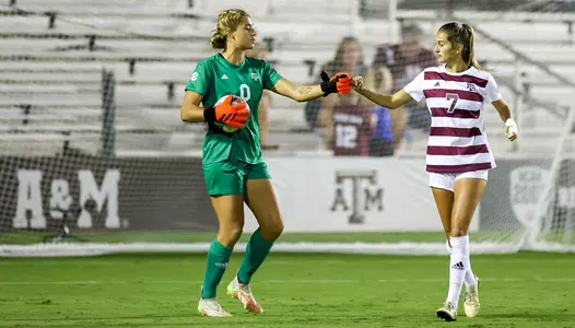 Goalkeeper Kenna Caldwell and center back Katie Smith fist bump after a Caldwell save.
