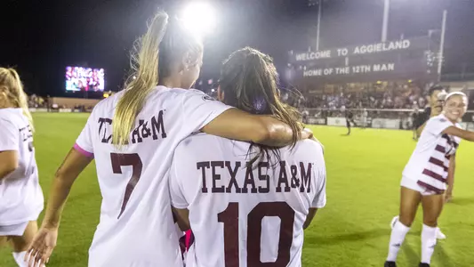 Katie Smith and Barbara Olivieri embrace with back to camera