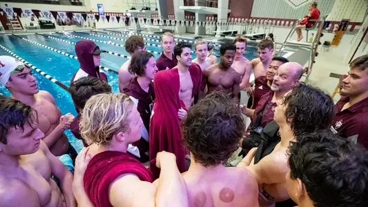 Texas A&M men's swimming team huddle after the meet