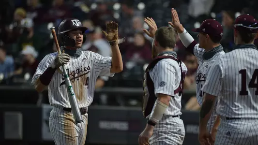Kalae Harrison high fives teammates during win against Oklahoma