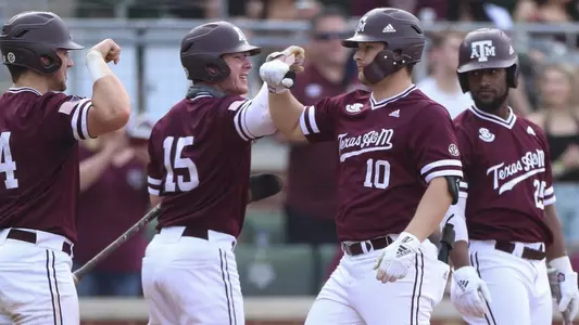 Hunter Coleman greeted at home plate by teammates after dinger versus Samford