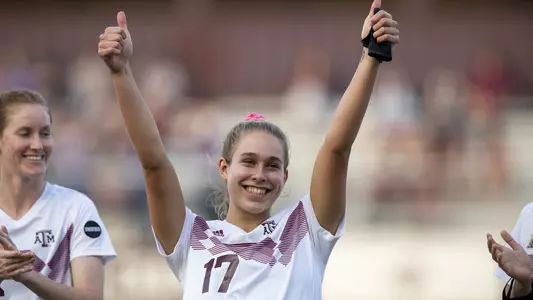 Lauren Geczik gives a double Gig'em in pregame introductions.