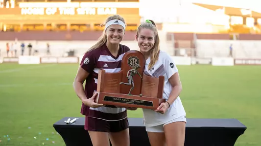 Kenna Caldwell and Lauren Geczik pose with the 2020 SEC regular season trophy