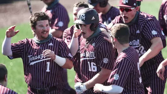 Ryan Targac is welcomed at home plate following a dinger at Missouri