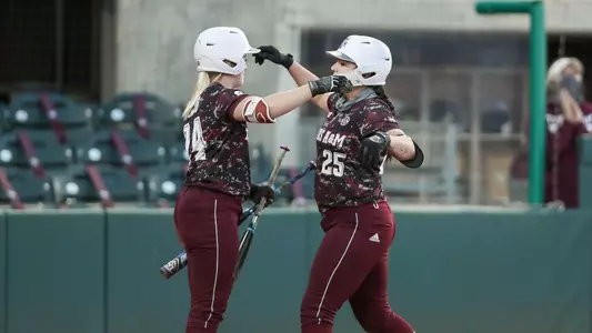 Haley Lee is greeted at home plate by Shaylee Ackerman after hitting a home run.