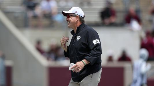 Jimbo Fisher laughs during the first half of Saturday's maroon and white game.