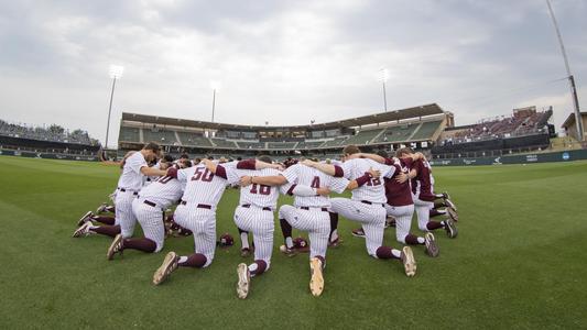 Aggies huddled in the outfield