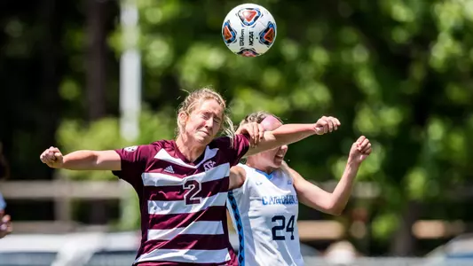Kate Colvin fights off a handsy North Carolina defender to win a header.