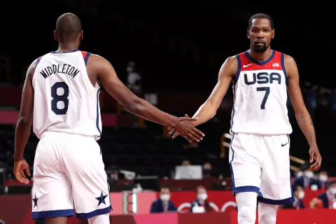 SAITAMA, JAPAN - JULY 31: Kevin Durant #7 of Team United States high-fives teammate Khris Middleton during the second half of a Men's Basketball Preliminary Round Group A game on day eight of the Tokyo 2020 Olympic Games at Saitama Super Arena on July 31, 2021 in Saitama, Japan. (Photo by Ezra Shaw/Getty Images)