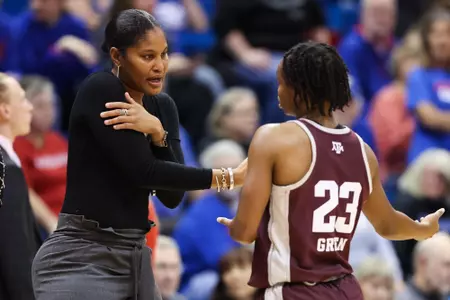 LAWRENCE, KS - November 30, 2022 - Associate Head Coach Chelsea Newton of the Texas A&M Aggies and Guard McKinzie Green #23 of the Texas A&M Aggies during the game between the Kansas Jayhawks and the Texas A&M Aggies at Allen Fieldhouse in Lawrence, KS. Photo By Ethan Mito/Texas A&M Athletics