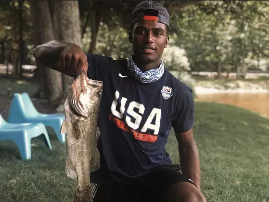 Henry Coleman III holds up a fresh catch.