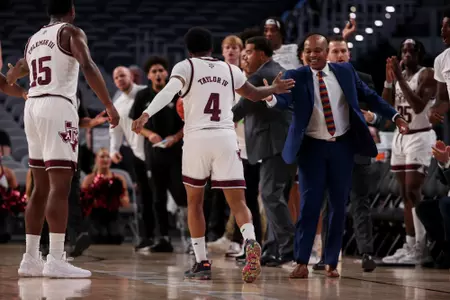 FORT WORTH, TX - December 03, 2022 - Associate Coach Devin Johnson of the Texas A&M Aggies and Guard Wade Taylor IV #4 of the Texas A&M Aggies during the game between the Boise State Broncos and the Texas A&M Aggies at DickieÕs Arena in Fort Worth, TX. Photo By Craig Bisacre/Texas A&M Athletics