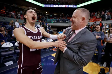 AUBURN, AL - MARCH 04, 2020 - guard Andre Gordon #20 of the Texas A&M Aggies and Buzz Williams Head Coach of the Texas A&M Aggies celebrate during the men?s basketball game between the Auburn Tigers and the Texas A&M Aggies at Auburn Arena in Auburn,AL. Photo By Craig Bisacre/Texas A&M Athletics