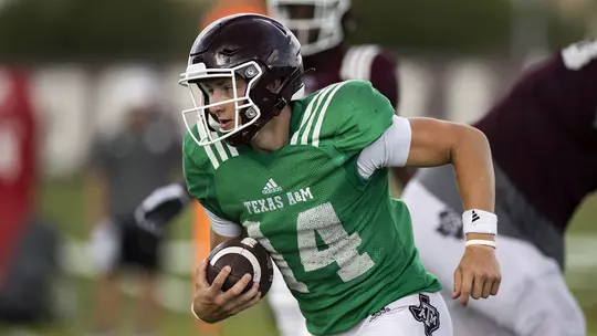 QB Max Johnson running during practice
