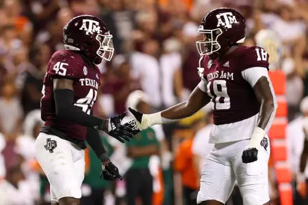 COLLEGE STATION, TX - September 17, 2022 - Linebacker Edgerrin Cooper #45 of the Texas A&M Aggies and Defensive lineman Lebbeus Overton #18 of the Texas A&M Aggies during the game between the Miami Hurricanes and the Texas A&M Aggies at Kyle Field in College Station, TX. Photo By Sydney Morriss/Texas A&M Athletics