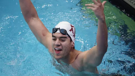 Alex Sanchez celebrates after setting the school record in the 100 breast