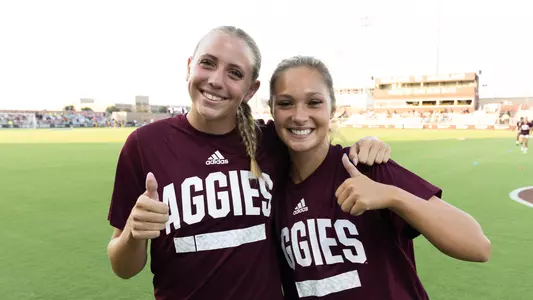 Carolyn Calzada and Sydney Becerra flash GigEm thumbs in their pregame garb.