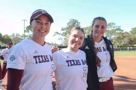 COLLEGE STATION, TX - February 18, 2023 - Outfielder Allie Enright #33 of the Texas A&M Aggies, Pitcher Emily Leavitt #25 of the Texas A&M Aggies, and Pitcher Emiley Kennedy #11 of the Texas A&M Aggies during the game between the USF Bulls and the Texas A&M Aggies at Eddie C. Moore Complex in Clearwater, FL. Photo By Brendall O'Banon/Texas A&M Athletics
