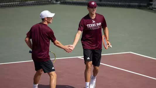 COLLEGE STATION, TX - March 14, 2023 - Kenner Taylor of the Texas A&M Aggies and Pierce Rollins of the Texas A&M Aggies during the game between the Abilene Christian Wildcats and the Texas A&M Aggies at Mitchell Tennis Center in College Station, TX. Photo By Evan Pilat/Texas A&M Athletics