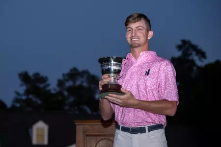 Amateur Sam Bennett of the United States lifts the Low Amateur Silver Cup during the Green Jacket ceremony following the final round of the 2023 Masters Tournament at Augusta National Golf Club, Sunday, April 9, 2023.