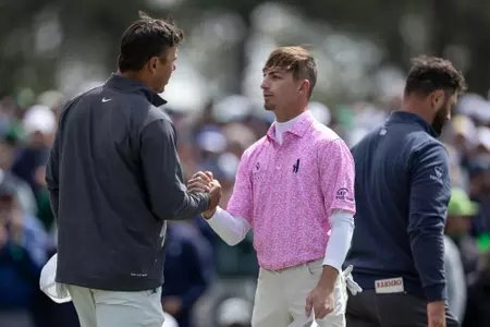 Brooks Koepka of the United States and Amateur Sam Bennett of the United States shake hands on the No. 18 green after the continuation of the third round of the 2023 Masters Tournament at Augusta National Golf Club, Sunday, April 9, 2023.