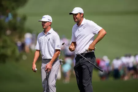 Masters champion Scottie Scheffler of the United States and Amateur Sam Bennett of the United States talk during the second round of the 2023 Masters Tournament at Augusta National Golf Club, Friday, April 7, 2023.