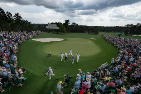 Masters champion Scottie Scheffler of the United States, Max Homa of the United States and Amateur Sam Bennett of the United States leave the No. 18 green at the end of their round after the second round of the 2023 Masters Tournament at Augusta National Golf Club, Friday, April 7, 2023.