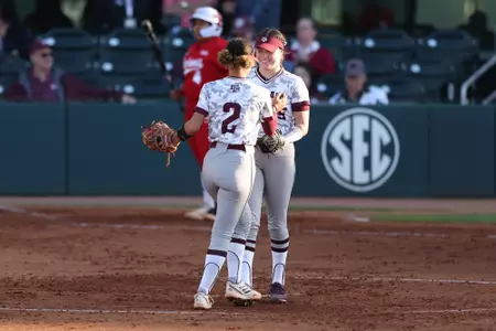 COLLEGE STATION, TX - April 12, 2023 - Infielder Rylen Wiggins #2 of the Texas A&M Aggies and Pitcher Emily Leavitt #25 of the Texas A&M Aggies during the game between the Louisiana Ragin' Cajuns and the Texas A&M Aggies at Davis Diamond in College Station, TX. Photo By Evan Pilat/Texas A&M Athletics