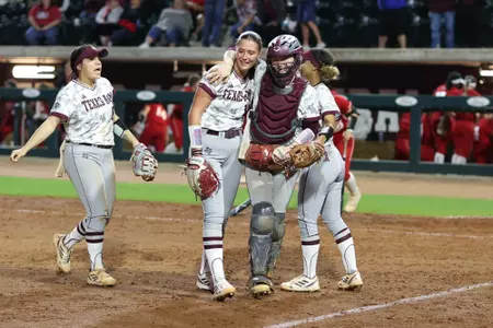 COLLEGE STATION, TX - April 12, 2023 - Pitcher Emiley Kennedy #11 of the Texas A&M Aggies and Catcher Julia Cottrill #42 of the Texas A&M Aggies during the game between the Louisiana Ragin' Cajuns and the Texas A&M Aggies at Davis Diamond in College Station, TX. Photo By Evan Pilat/Texas A&M Athletics