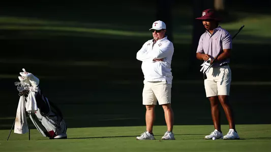 Head Coach Brian Kortan and Phichaksn Maichon scope out the lay of the land from a fairway at Colonial Country Club.