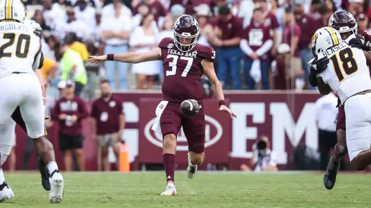 Tyler White punting the ball against Missouri