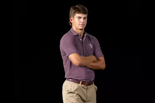 Aaron Pounds with arms folded at media day portrait shoot