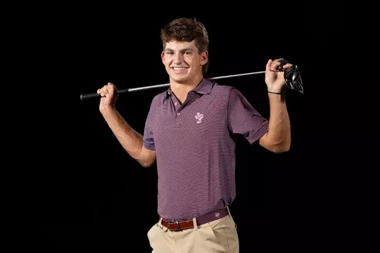 Aaron Pounds in the Bo Jackson pose with golf club behind head at media day portrait shoot