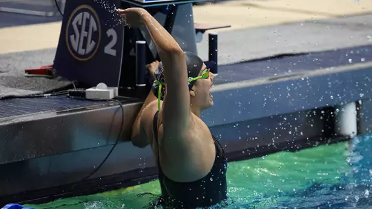 Miranda Grana celebrates at the wall during the SEC Swimming & Diving Championships