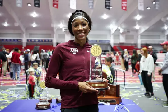Lamara Distin poses with the SEC Indoor Scholar Athlete of the Year award.