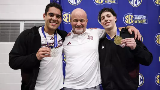 COLLEGE STATION, TX - February 21, 2024 - Alex Sanchez of the Texas A&M Aggies, Head Coach Jay Holmes of the Texas A&M Aggies and Baylor Nelson of the Texas A&M Aggies during the SEC Swimming and Diving Championships game at Rec Center Natatorium in College Station, TX. Photo By Ethan Mito/Texas A&M Athletics