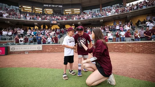 COLLEGE STATION, TX - March 30, 2024 - Play ball kid during the game between the Auburn Tigers and the Texas A&M Aggies at Blue Bell Park in College Station, TX. Photo By Ethan Mito/Texas A&M Athletics