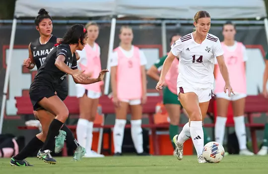 Kennedy Clark is working over a defender while donning the all white kits at Lamar