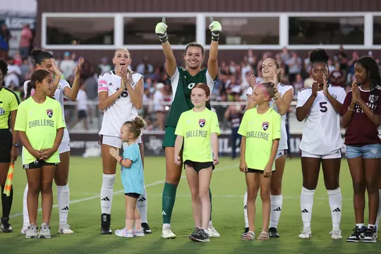 Sydney Fuller flashes a double goalkeeper glove Gig 'em in the pregame introductions against Fairfield.