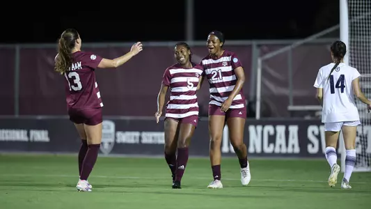 Teammates Jazmine Wilkinson and Mia Pante express joy toward goal-scorer MaKhiya McDonald
