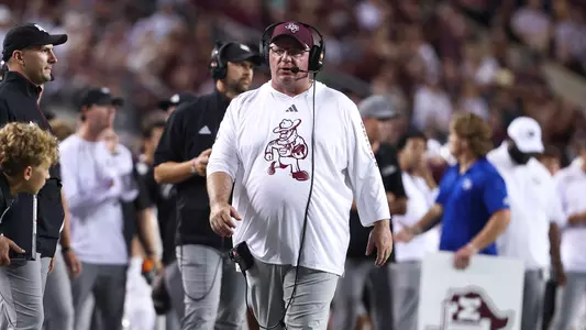 Mike Elko walks the sideline in a headset against notre dame.